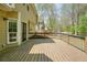 The backyard deck is ready for entertaining with railing and a view of the wooded backyard at 1010 Allenbrook Ln, Roswell, GA 30075