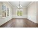 Bright dining room featuring wood floors, chandelier, and ample windows at 1010 Allenbrook Ln, Roswell, GA 30075