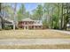 Spacious two-story brick home with a long driveway, mature trees, and a well-maintained lawn at 1010 Allenbrook Ln, Roswell, GA 30075