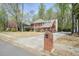 Spacious two-story brick home with a long driveway, mature trees, and a well-maintained lawn at 1010 Allenbrook Ln, Roswell, GA 30075