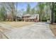Spacious two-story brick home with a long driveway, mature trees, and a well-maintained lawn at 1010 Allenbrook Ln, Roswell, GA 30075