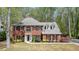 Stately brick home with well-manicured lawn and symmetrical design, showcasing classic curb appeal at 1010 Allenbrook Ln, Roswell, GA 30075