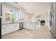 Open kitchen with white cabinets, subway tile backsplash, and stainless appliances at 1010 Allenbrook Ln, Roswell, GA 30075
