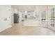 Bright kitchen with stainless steel appliances, tile floors, and granite counters at 1010 Allenbrook Ln, Roswell, GA 30075
