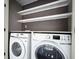 Modern laundry room with white washer and dryer and shelving at 1010 Allenbrook Ln, Roswell, GA 30075