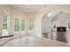 Open living room with fireplace, arched entrance, and double doors at 1010 Allenbrook Ln, Roswell, GA 30075