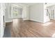 Open-concept living room with wood floors and view to dining room at 1010 Allenbrook Ln, Roswell, GA 30075