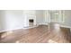 Spacious living room with wood flooring, fireplace and plenty of natural light at 1010 Allenbrook Ln, Roswell, GA 30075