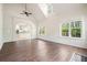 Open-concept living room with vaulted ceilings, wood floors, and ample windows at 1010 Allenbrook Ln, Roswell, GA 30075