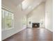 Vaulted living room featuring a fireplace and large windows for ample natural light at 1010 Allenbrook Ln, Roswell, GA 30075