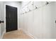 Mudroom features a black door and paneled wall with hooks at 1010 Allenbrook Ln, Roswell, GA 30075