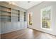Office with built-in bookshelves, storage cabinets, wood floors, recessed lighting, and two windows with views of the yard at 1010 Allenbrook Ln, Roswell, GA 30075