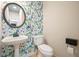 Charming powder room featuring floral wallpaper and pedestal sink at 1010 Allenbrook Ln, Roswell, GA 30075