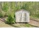 Charming backyard storage shed with double doors, providing convenient outdoor storage solutions at 1010 Allenbrook Ln, Roswell, GA 30075