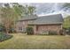 Expansive backyard featuring an outdoor patio with seating, lush lawn and perimeter landscaping, and mature trees at 4503 Payton Oaks Ne Pl, Atlanta, GA 30345