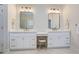 Bathroom featuring double vanity with modern lighting and framed mirrors at 4503 Payton Oaks Ne Pl, Atlanta, GA 30345