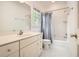 Full bath with shower-tub combo, white vanity, and hexagon tile flooring at 4503 Payton Oaks Ne Pl, Atlanta, GA 30345