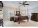 Spacious bedroom with a four-poster bed, neutral carpet, and large windows at 4503 Payton Oaks Ne Pl, Atlanta, GA 30345