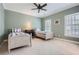 Charming bedroom featuring twin beds, ceiling fan, and natural light from shuttered windows at 4503 Payton Oaks Ne Pl, Atlanta, GA 30345