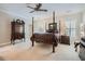 Spacious bedroom with a four-poster bed, neutral carpet, and traditional furnishings at 4503 Payton Oaks Ne Pl, Atlanta, GA 30345