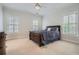 Spacious bedroom featuring a ceiling fan, carpet, and windows with shutters at 4503 Payton Oaks Ne Pl, Atlanta, GA 30345