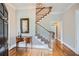 Elegant foyer with hardwood floors, staircase, decorative table, and soft neutral wall colors at 4503 Payton Oaks Ne Pl, Atlanta, GA 30345