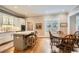 Bright kitchen features an island with seating, white cabinets, and stainless appliances at 4503 Payton Oaks Ne Pl, Atlanta, GA 30345