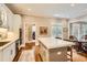 Well-lit kitchen with island seating, white cabinets, stainless steel appliances, and hardwood floors at 4503 Payton Oaks Ne Pl, Atlanta, GA 30345