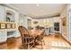 Eat-in kitchen boasts hardwood floors, white cabinetry, and an island with space for seating at 4503 Payton Oaks Ne Pl, Atlanta, GA 30345