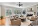Bright living room boasts hardwood floors, fireplace, and large windows with a view to a landscaped yard at 4503 Payton Oaks Ne Pl, Atlanta, GA 30345