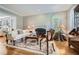 Cozy living room features a fireplace, hardwood floors, detailed molding, and large windows with shutters at 4503 Payton Oaks Ne Pl, Atlanta, GA 30345