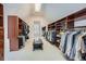 Large walk-in closet with custom shelving, ample storage space for clothes and shoes at 4503 Payton Oaks Ne Pl, Atlanta, GA 30345
