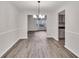 Open-concept dining room with modern chandelier, seamlessly connected to the kitchen at 4720 Buffalo St, Fairburn, GA 30213