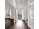 Bright entryway boasts sleek, dark wood floors and a contemporary pendant light fixture at 4720 Buffalo St, Fairburn, GA 30213