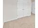 Hallway featuring double door closet with neutral carpeting at 4720 Buffalo St, Fairburn, GA 30213