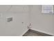 Functional laundry room with hookups and shelving at 4720 Buffalo St, Fairburn, GA 30213