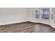 Inviting living room showcasing beautiful wood flooring and large bay windows at 4720 Buffalo St, Fairburn, GA 30213