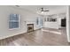 Bright living room with hardwood floors, a fireplace, and a ceiling fan at 4720 Buffalo St, Fairburn, GA 30213