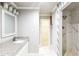 A bathroom features a sink with granite countertop and a tiled shower at 4820 Camden Sw Dr, Conyers, GA 30094