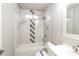 This bathroom features a shower-tub combo with decorative tiles, providing a stylish and functional space at 4820 Camden Sw Dr, Conyers, GA 30094