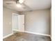 Neutral bedroom features a ceiling fan and white door at 4820 Camden Sw Dr, Conyers, GA 30094