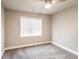 A bedroom features neutral walls, carpet, and a bright window at 4820 Camden Sw Dr, Conyers, GA 30094