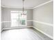 A view of an elegant dining room with large window and wood-look flooring at 4820 Camden Sw Dr, Conyers, GA 30094