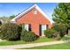 Close-up of brick home with well-maintained landscaping and shutters at 4820 Camden Sw Dr, Conyers, GA 30094