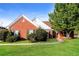 Charming single-story red brick home with well-manicured lawn and mature landscaping at 4820 Camden Sw Dr, Conyers, GA 30094
