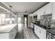 Spacious kitchen with white cabinetry, stainless steel appliances, and granite counters open to the living areas at 4820 Camden Sw Dr, Conyers, GA 30094