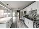 Contemporary kitchen featuring a large island, stainless appliances, and sleek white cabinets at 4820 Camden Sw Dr, Conyers, GA 30094