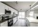 Modern kitchen features granite counters, stainless steel appliances, and mosaic tile backsplash at 4820 Camden Sw Dr, Conyers, GA 30094