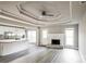 Open-concept living room features gray wood floors, fireplace, and a modern kitchen at 4820 Camden Sw Dr, Conyers, GA 30094