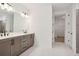 Bathroom features a double vanity, modern fixtures, and a seamless transition to the walk-in closet at 5133 Aster Bnd, Canton, GA 30114
